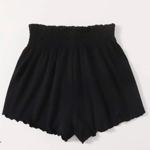 black shirred waist lettuce trim shorts